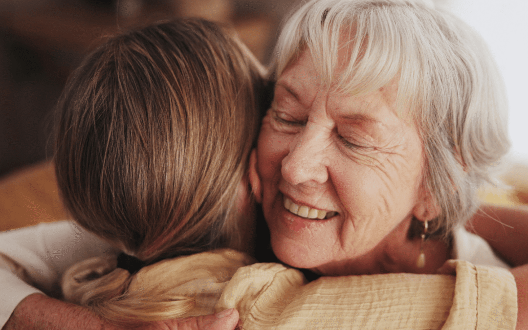 Woman, love and hug senior mom in home for mothers day, bonding and visit in retirement with care or happy. Person, smile and embrace with elderly parent for reunion, comfort and affection