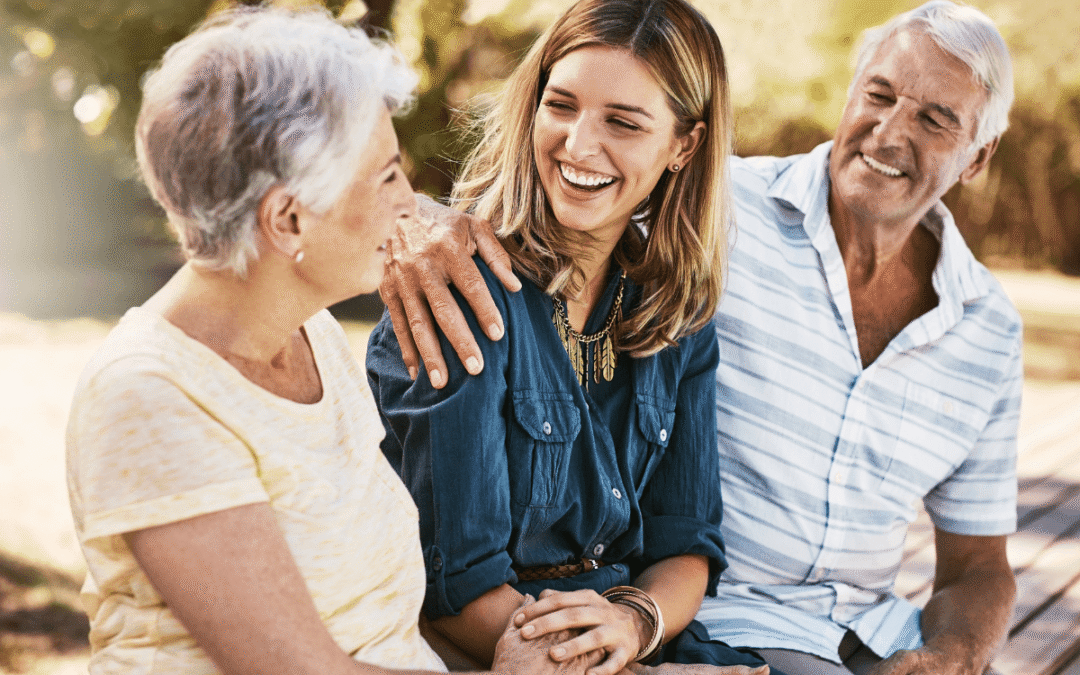 Woman enjoying time outdoors with older parents.