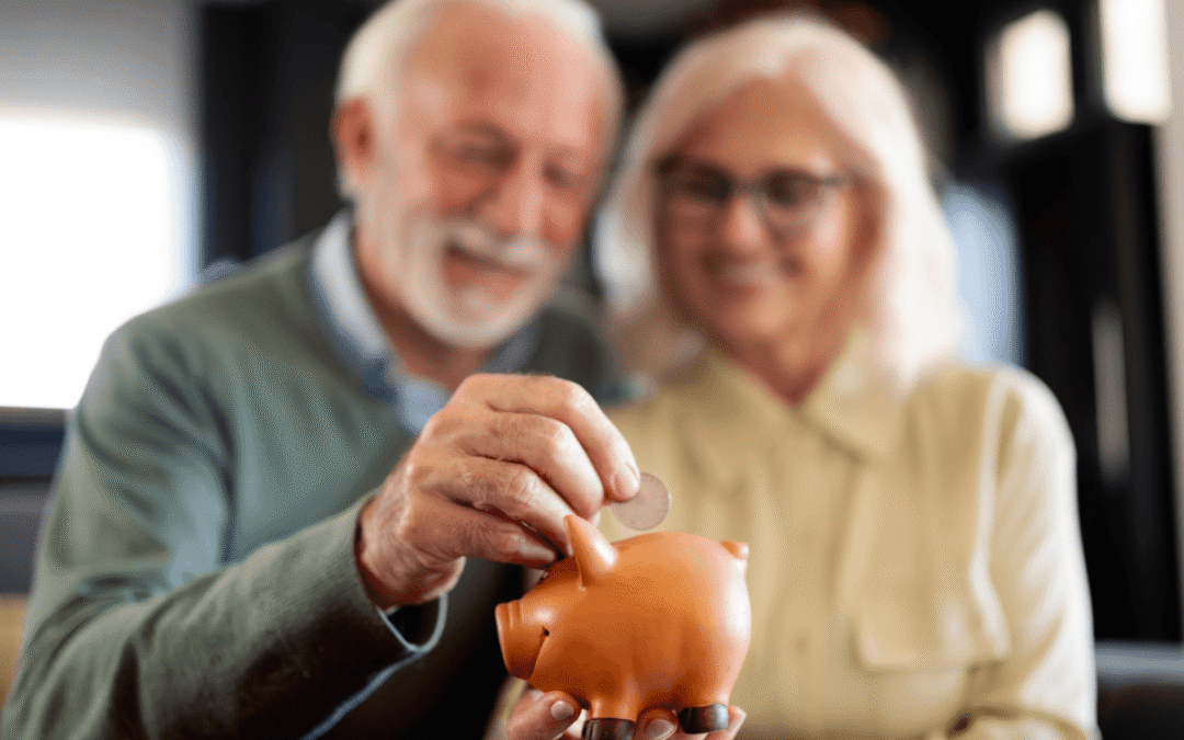 Happy senior couple at home holding a piggy bank, smiling with warmth and trust.
